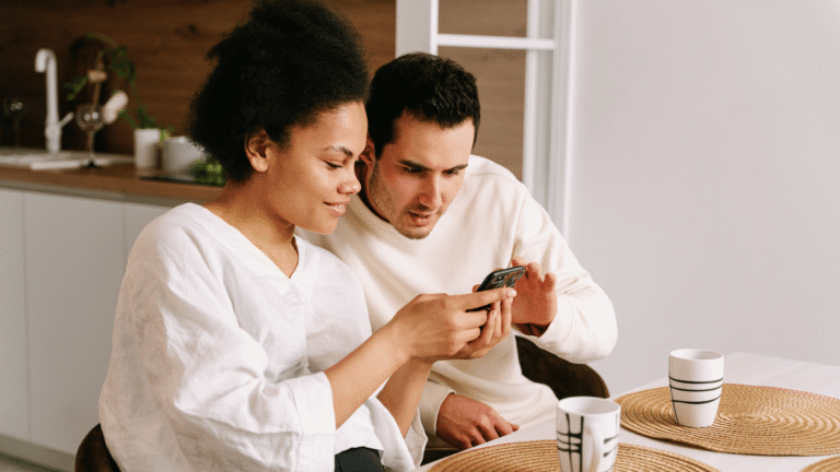 Couple comparing auto insurance quotes on a phone