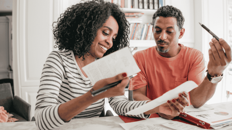 Couple looking at papers to discuss budget