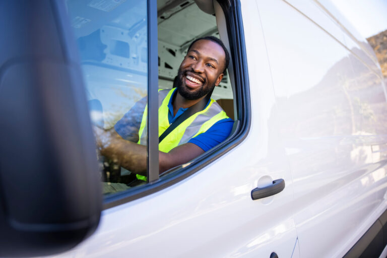 Smiling delivery driver in a van